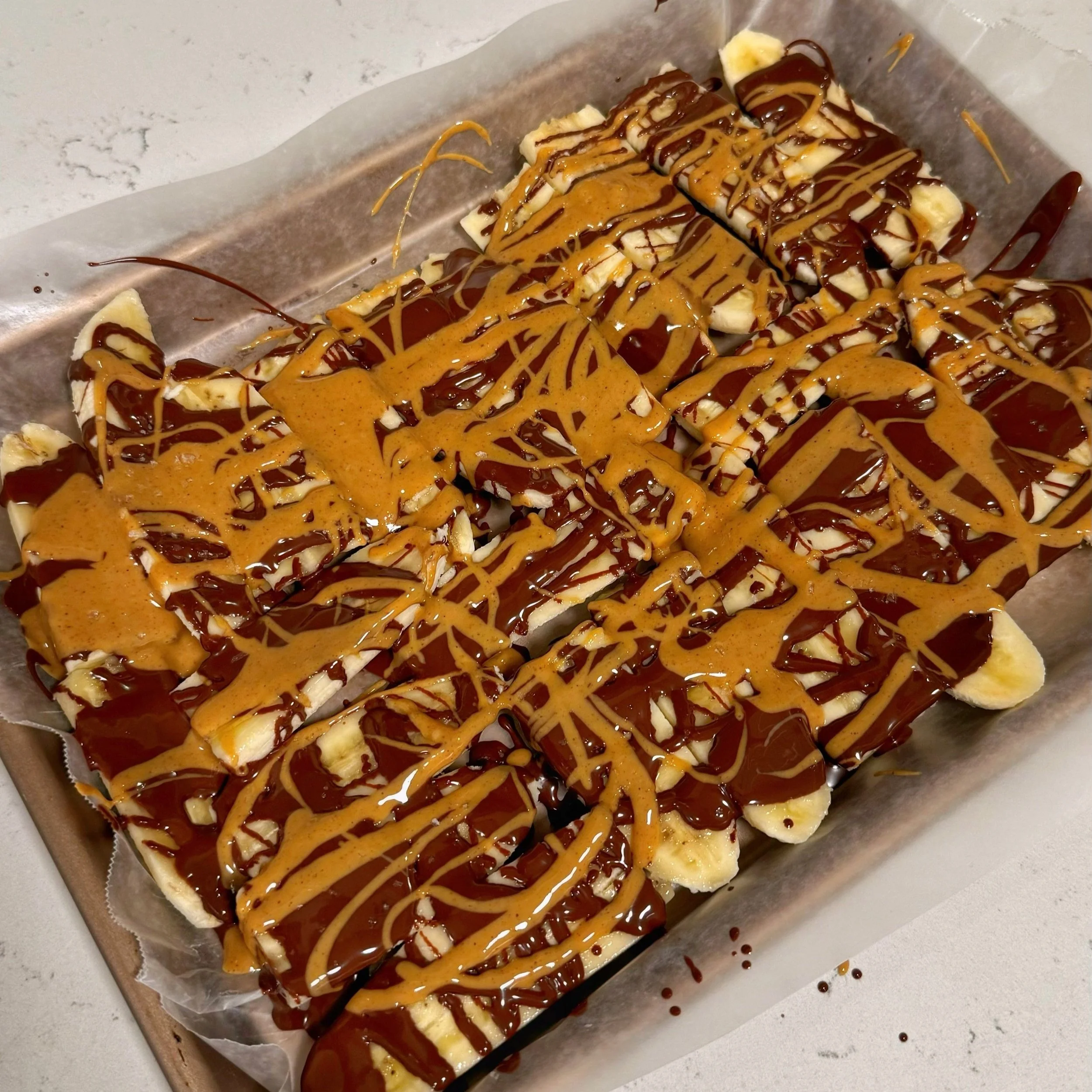 A pan of chocolate peanut butter dessert sliced into small portions.