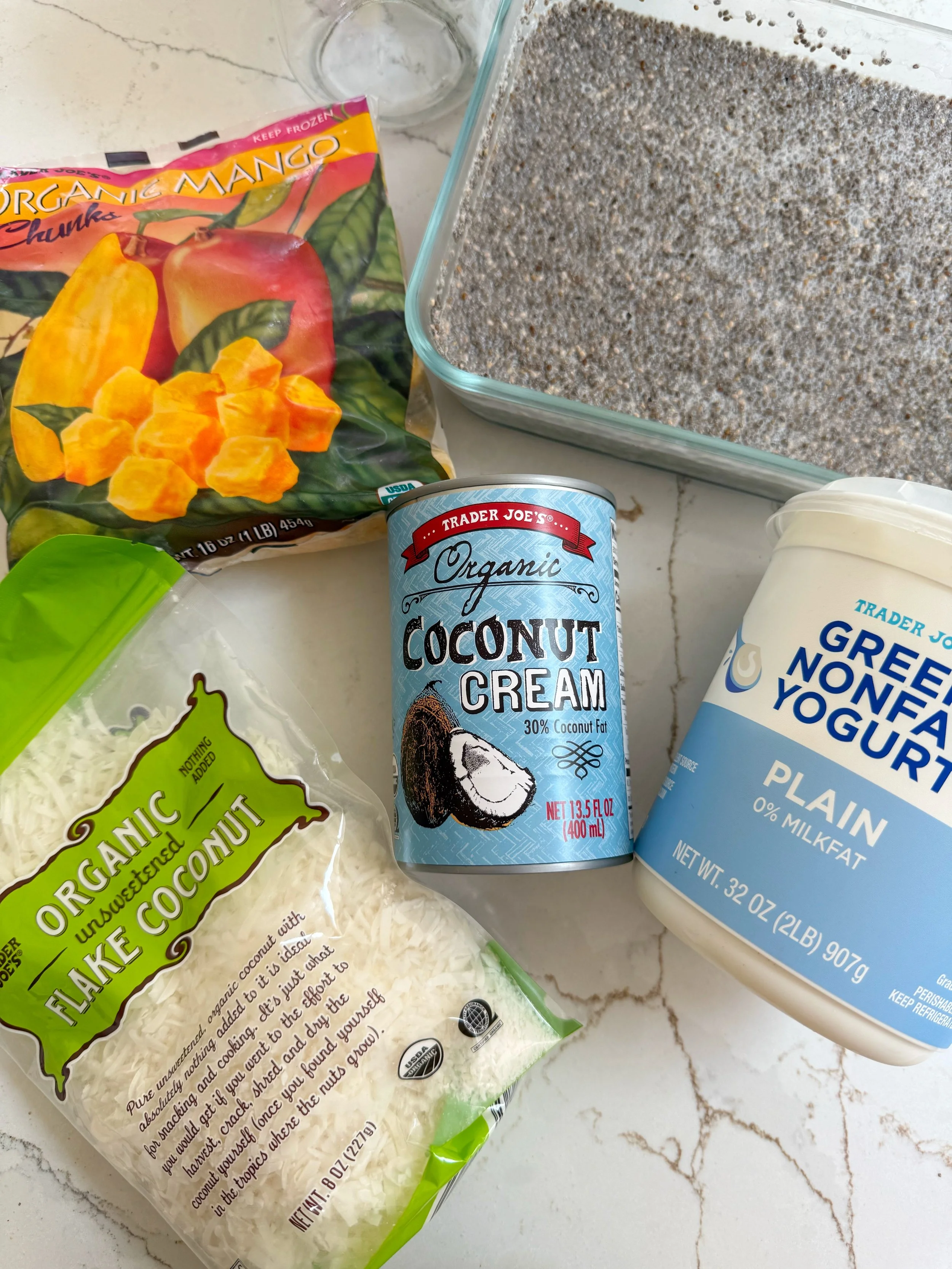 All the ingredients to make mango coconut chia seed pudding sitting on top of a countertop.