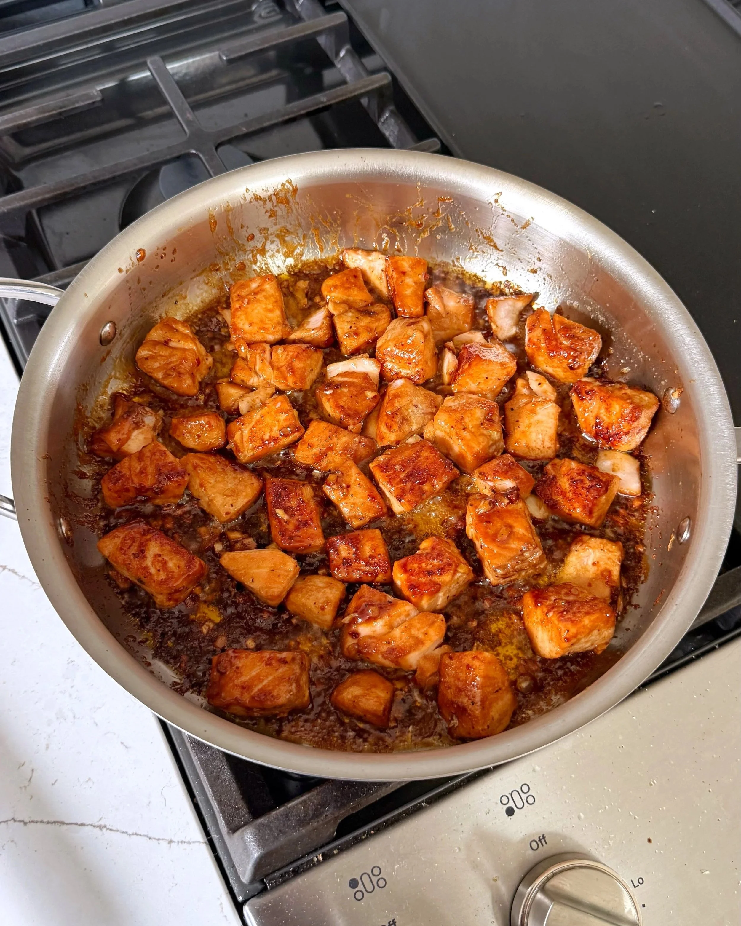 A pan of saucy garlic salmon. 
