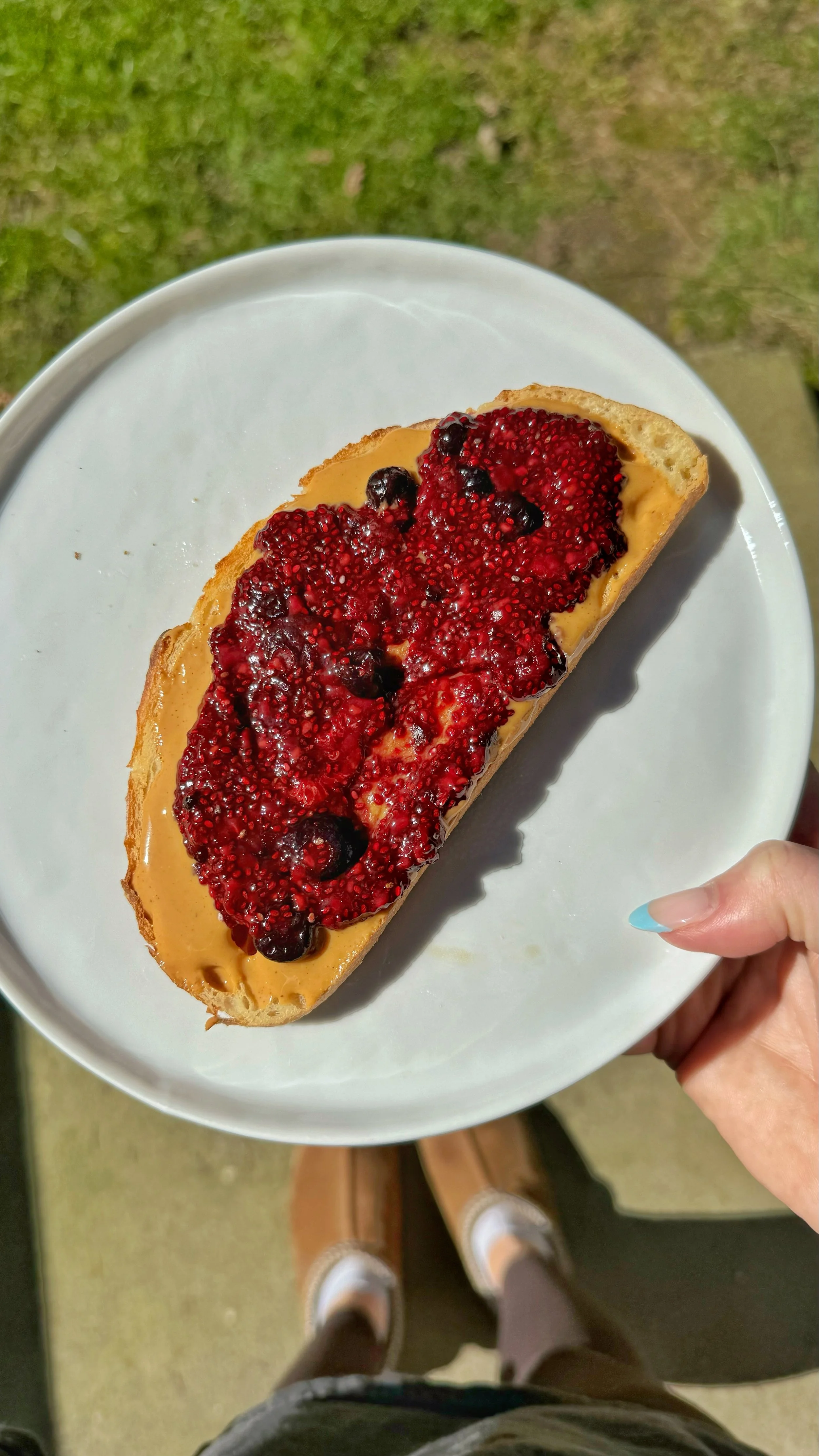 Berry chia jam on a piece of bread with peanut butter.