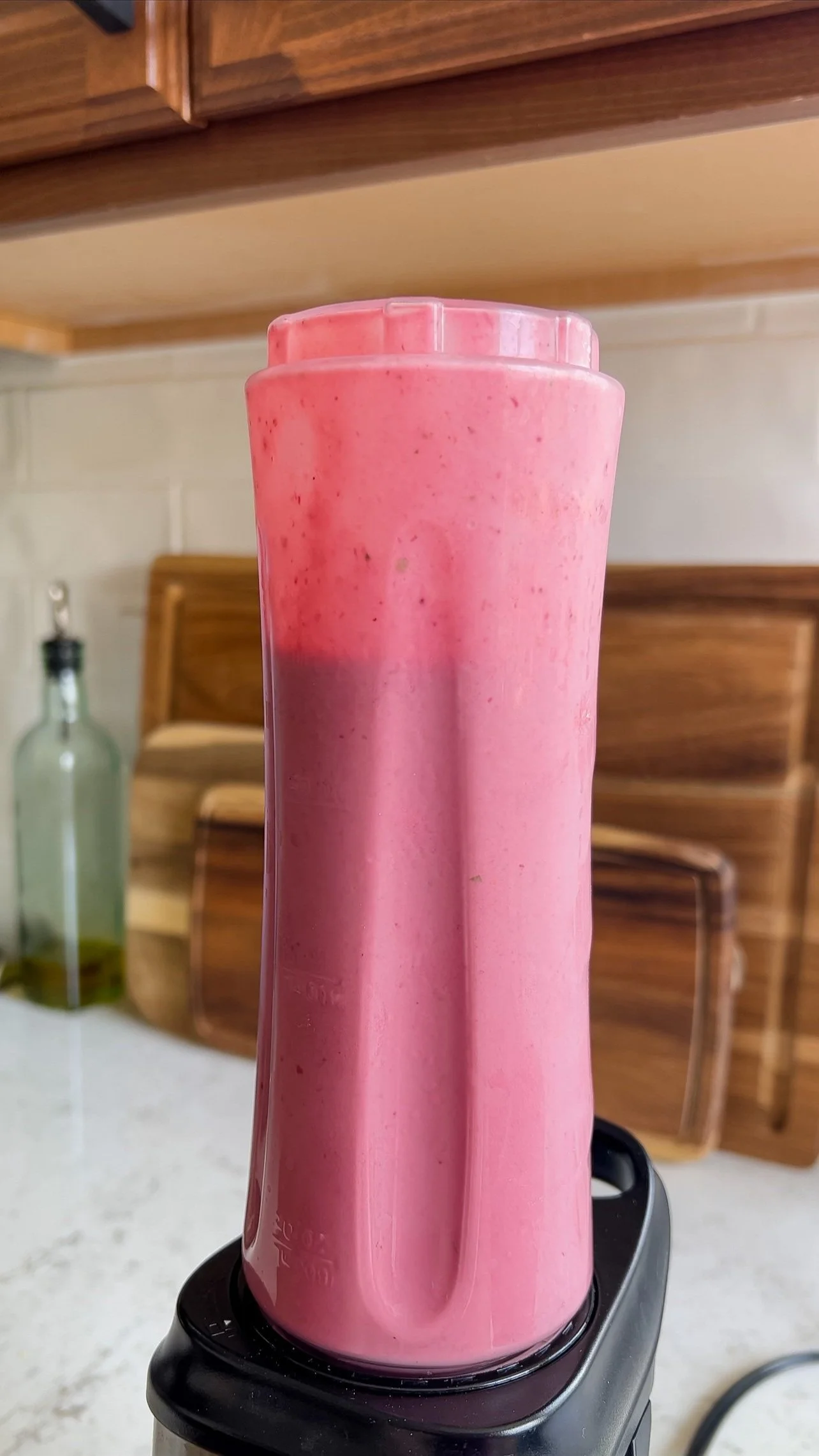 A blender with strawberry & cream protein shake in it.