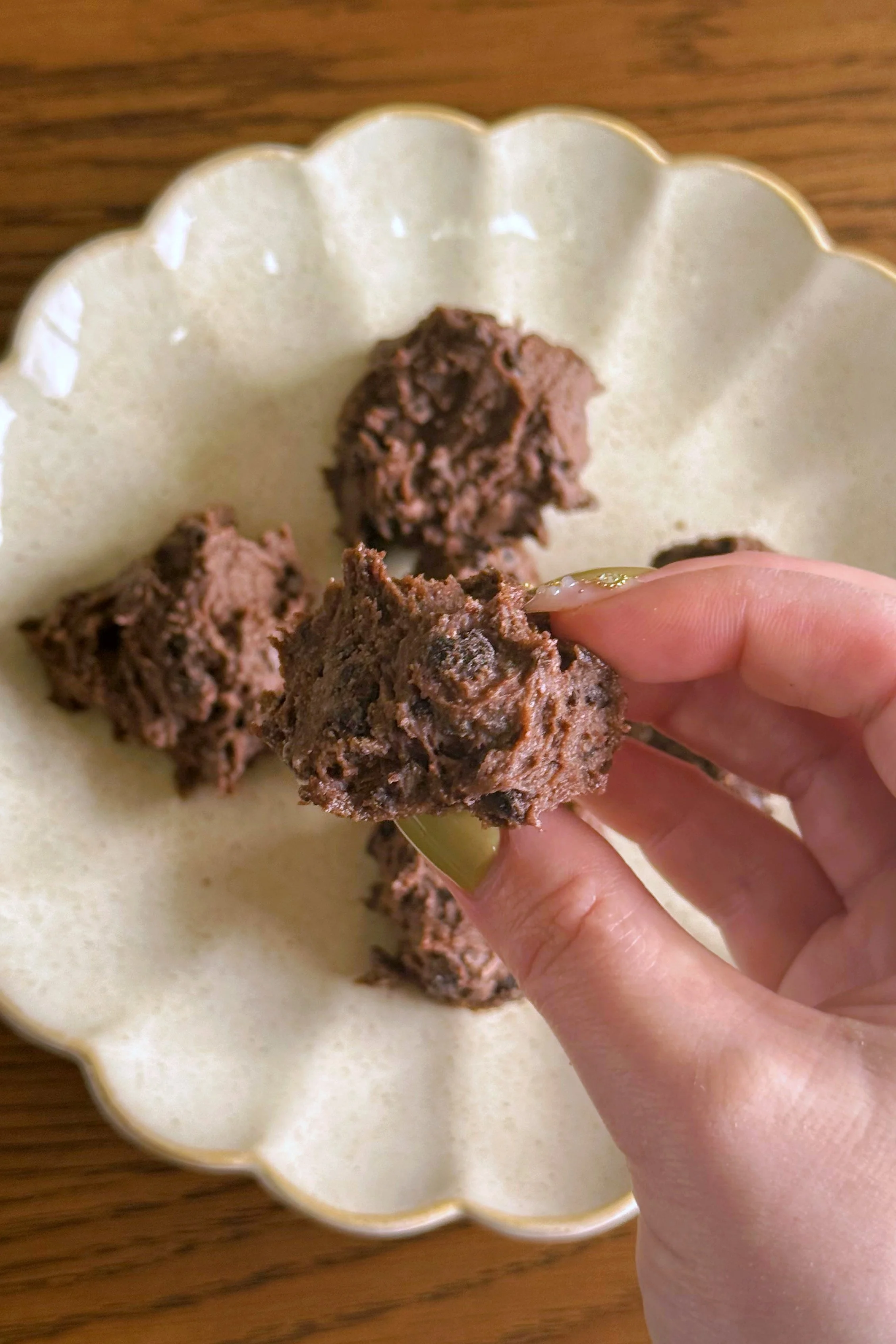 A Oreo bite being held up to the camera. 