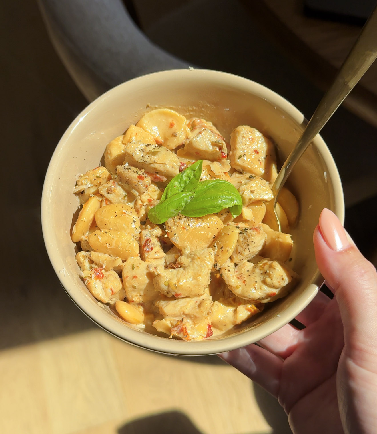 a bowl of beans and chicken in a creamy white sauce