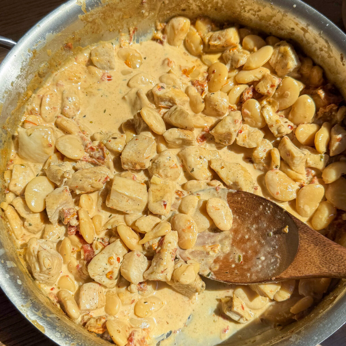 A golden, creamy Marry Me sauce coats tender chicken and hearty butter beans, garnished with fresh herbs and sun-dried tomatoes in this quick, one-pan meal.